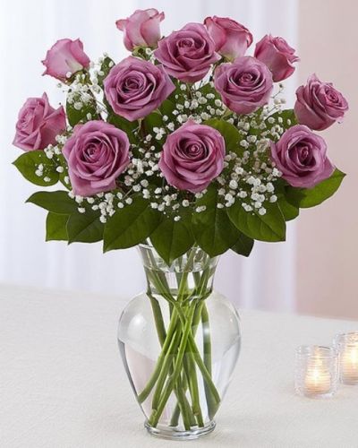 Lavender roses are artfully arranged in a classic glass urn vase. Choose from one dozen, 18 roses or two dozen roses.<del></del>
<hr />